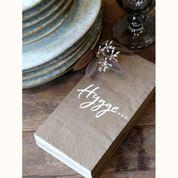 papirserviet med hygge tekst close up af serviet i varm mocca farve